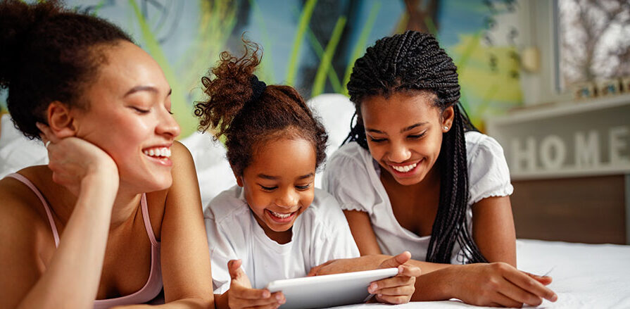 Family time-Smiling girl playing with mother and sister at home