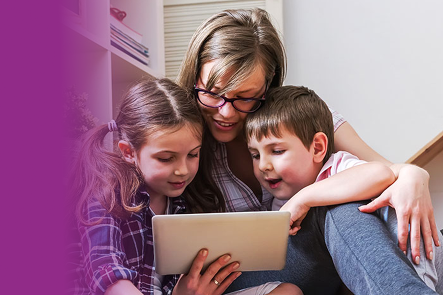 Mum and two children are looking at a tablet together.